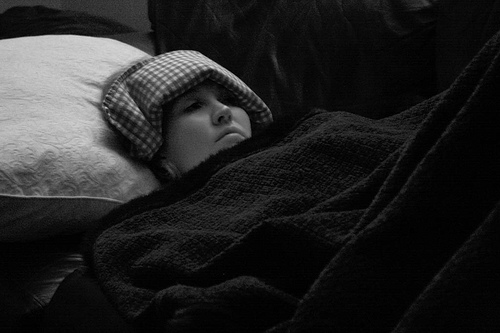 girl in bed with migraine girl in bed with migraine