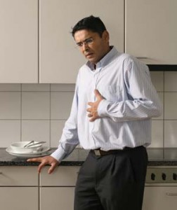 man in pain holding his chest